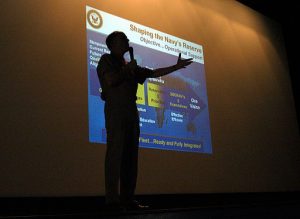 US_Navy_040605-N-6633C-002_Commander_Naval_Reserve_Force,_Vice_Adm__John_G__Cotton,_is_silhouetted_in_front_of_a_Powerpoint_slide_mapping_out_the_Naval_Reserve_Force's_future
