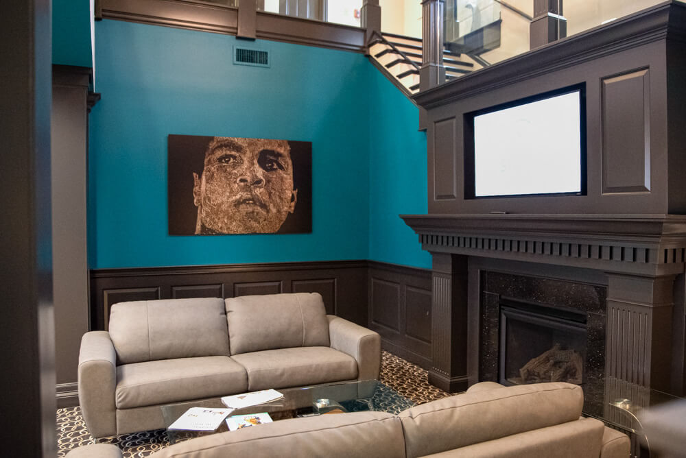 Interior lobby at the Louisville headquarters of C2 Strategic Communications with a portrait of Muhammad Ali.